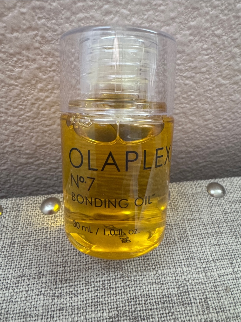 OLAPLEX No.7 Bonding Oil — clear bottle with golden oil